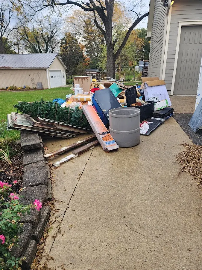 Dumpster being loaded with debris for Estate Cleanout Dumpster Rental in Nowthen